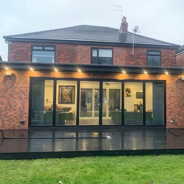 6 leaf bi folding doors in black featuring a black patio